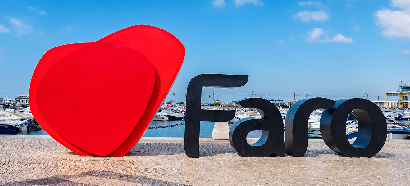 I love Faro sign with the marina to the rear